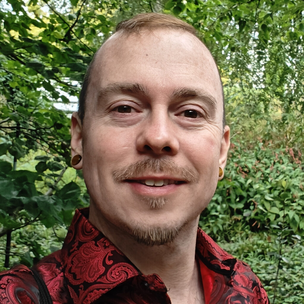 Kep Rinvelo wearing a red and black shirt